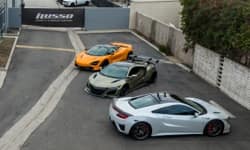 Three exotic cars parked outdoors